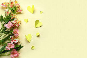 Composition with beautiful alstroemeria flowers and paper hearts on color background. Mother's day celebration