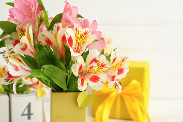 Vase with beautiful alstroemeria flowers on light background, closeup. Mother's day celebration