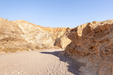 The dried  up river bed - the path to the Red Canyon, in the national reserve - the Red Canyon in the rays of the setting sun, near the city of Eilat, in southern Israel.