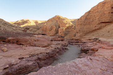 Fantastically beautiful landscape in the national nature reserve - Red Canyon in the rays of the setting sun, near the city of Eilat, in southern Israel