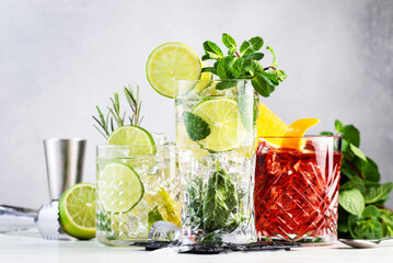 Most popular alcoholic cocktails set: mojito, gin tonic and negroni on gray background with bar...