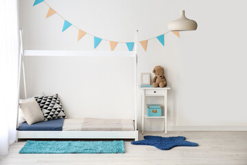 Stylish interior of children's room with baby bed