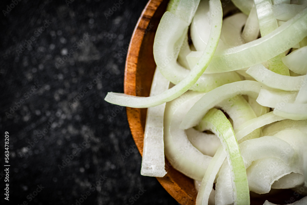 Poster Chopped onions in a wooden plate. 