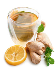 Cup of ginger tea, roots, lemon and mint on white background