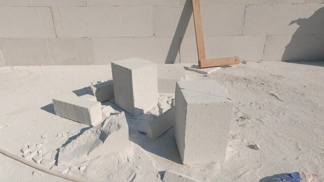 Overview of building site for construction of terrace with fireplace at backyard. Built wall, tools and bricks leftovers at the construction site on a summer day in garden with amazing view of valley.