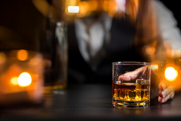 Fototapeta na wymiar Closeup businessmen holding a glass of whiskey