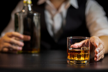 Closeup businessmen holding a glass of whiskey