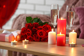 Naklejka na ściany i meble Burning candles, roses, champagne and gift for Valentine's Day on table in room, closeup