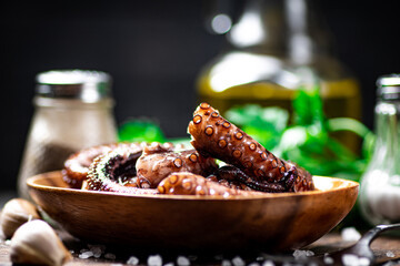 An octopus on a wooden plate. 