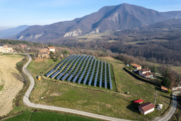 drone view of photovoltaic plant, panels for solar green energy generation, in mountain landscape