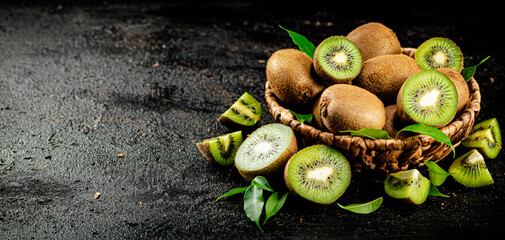 Fresh kiwi with leaves in a basket. 