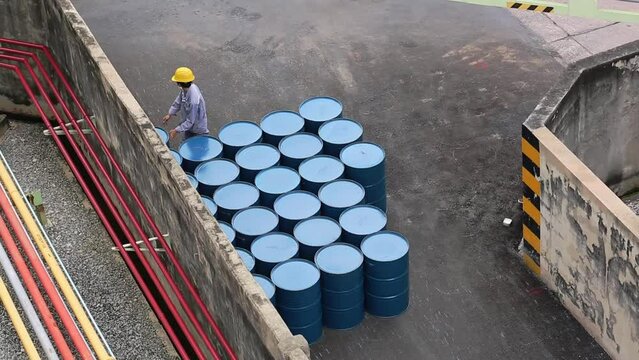 Top view oil barrels vertical move for on the male worker help arrange.