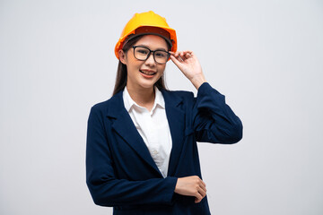 Portrait of Asian female engineer with hard hat isolated on grey background.