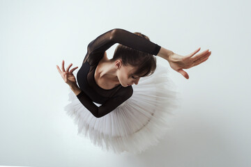 angle from above on a ballerina up to the waist with her hands showing a dance