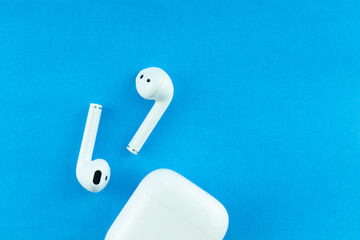 Wireless headphones or Bluetooth headphones on a blue background.