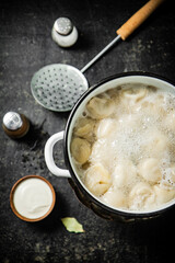 Dumplings in a pot of boiling water. 