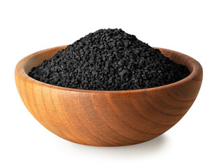 black cumin seeds in brown wooden bowl isolated on white
