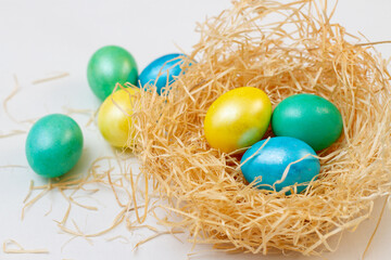 Fototapeta na wymiar Easter eggs in sawdust nest