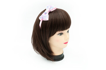 Female mannequin with hair band of colored on head.