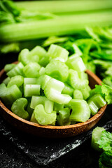 Pieces of fresh celery in a wooden plate. 