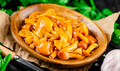 Marinated mushrooms on a plate with parsley. 