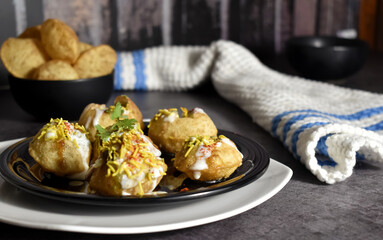 Selective Focus Picture of a Indian Snack called Dahi Puri with Coriander Leaf and Sev