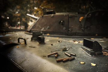 Toned photograph. A selective focus shot of an abandoned military tank in forest