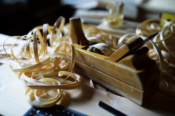 Plane jointer carpenter or joiner tool and wood shavings. Woodworking tools on wooden table....