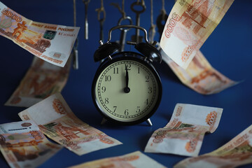 Retro keys on ropes in hand. Flying banknotes. Concept of business ideas.