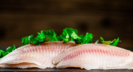 Raw fish fillet with parsley.