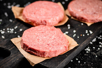 Raw burger on a cutting board. 