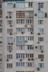 Fototapeta na wymiar Close-up windows of a multi-storey residential building. Modern residential real estate in the city