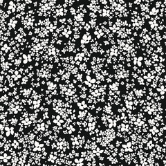 Hand Drawn small white flower in a dark background.Trendy liberty style seamless pattern, a lot of different flowers on the blooming field. Millefleurs background for fashion prints, textile, walpaper