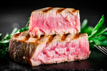Grilled tuna with parsley on the table. 
