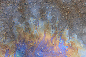 puddle gasoline background, wet oil multicolored rainbow pollution spill
