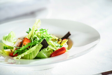 chicken salad with strawberry on the white plate