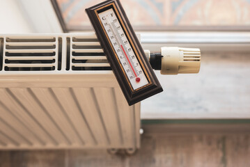 Low temperature on the thermometer in winter. Energy crisis. 17 degrees Celsius at room temperature.
