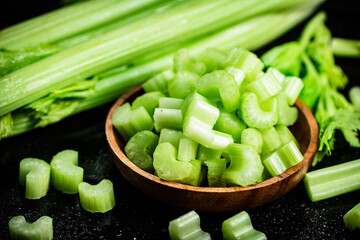 Pieces of fresh celery in a wooden plate. 