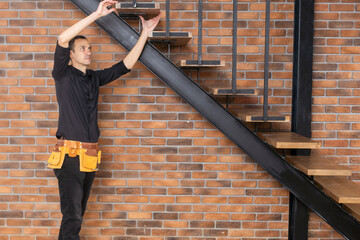 the worker is repairing the stairs