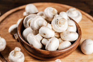 Mushrooms in a bowl on a cutting board. 