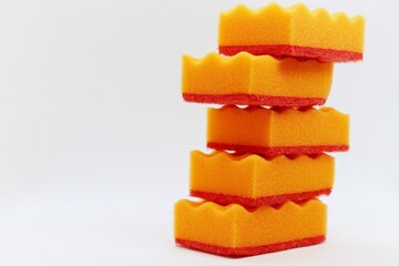Set of orange sponges for washing dishes