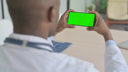 African Doctor Watching Smartphone with Chroma Key