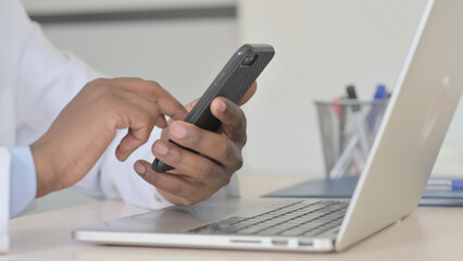 Close Up of African Doctor Using Smartphone