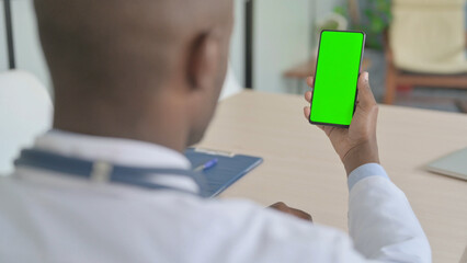 African Doctor Using Smartphone with Chroma Key