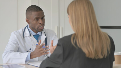 African Doctor Talking with Female Patient