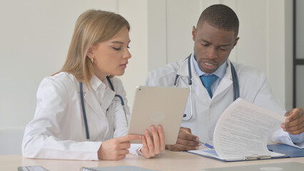 Female Doctor and African Doctor Working in Clinic
