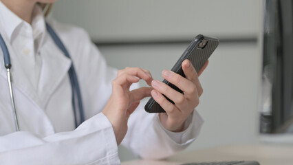 Close up of Female Doctor using Smartphone for Browsing Internet