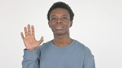 Fototapeta premium Young African Man Waving Hand to Say Hello on White Background
