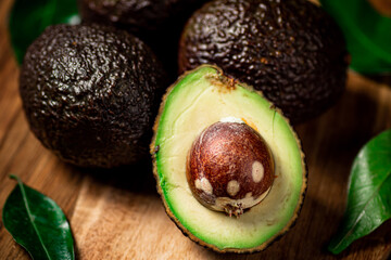 Halves of fresh avocado on a cutting board. 