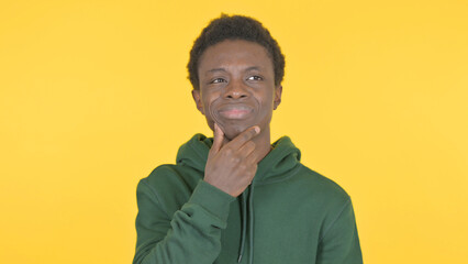 Fototapeta premium Brainstorming Young African Man Thinking Idea on Yellow Background